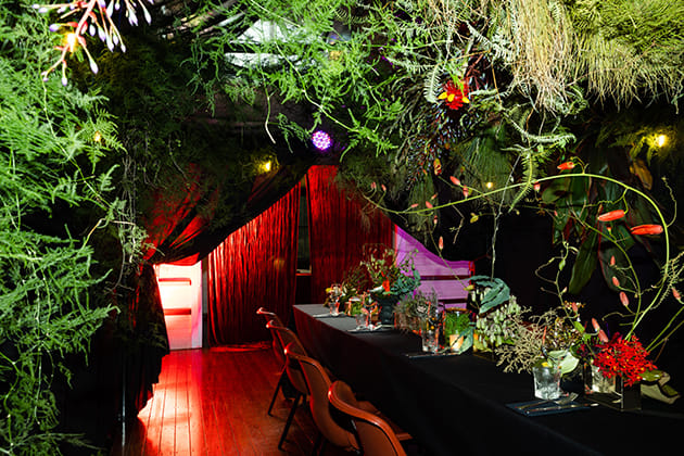 dinner table surrounded by plants