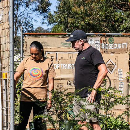 two peoplw looking at plants 