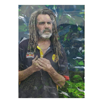 image of indigenous man surrounded by plants