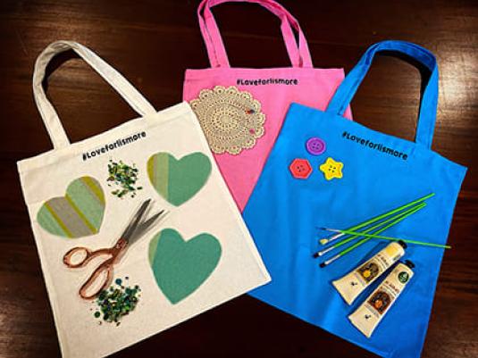three decorated tote bags