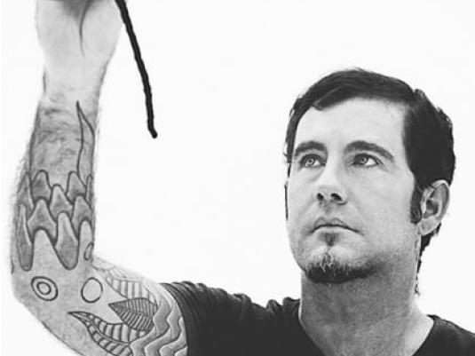 photo of Jeremy Hawkes with his arm raised