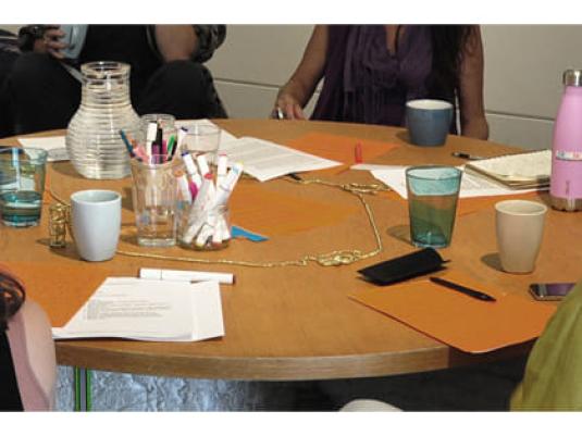 table with cups and writing equipment