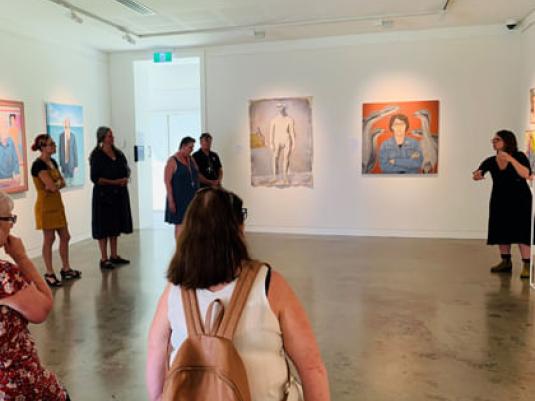 group of people viewing art the  in gallery with Auslan interpreterr