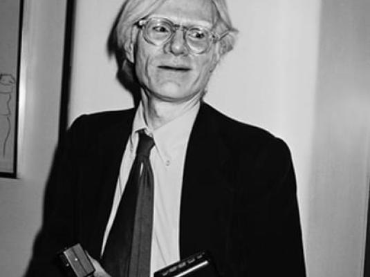 portrait of Andy Warhol in a suit and tie