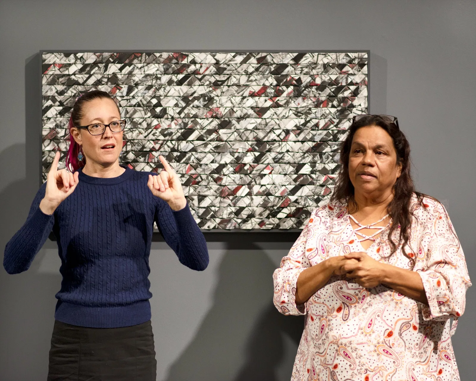 A woman 'signing' Auslan during a Welcome to Country