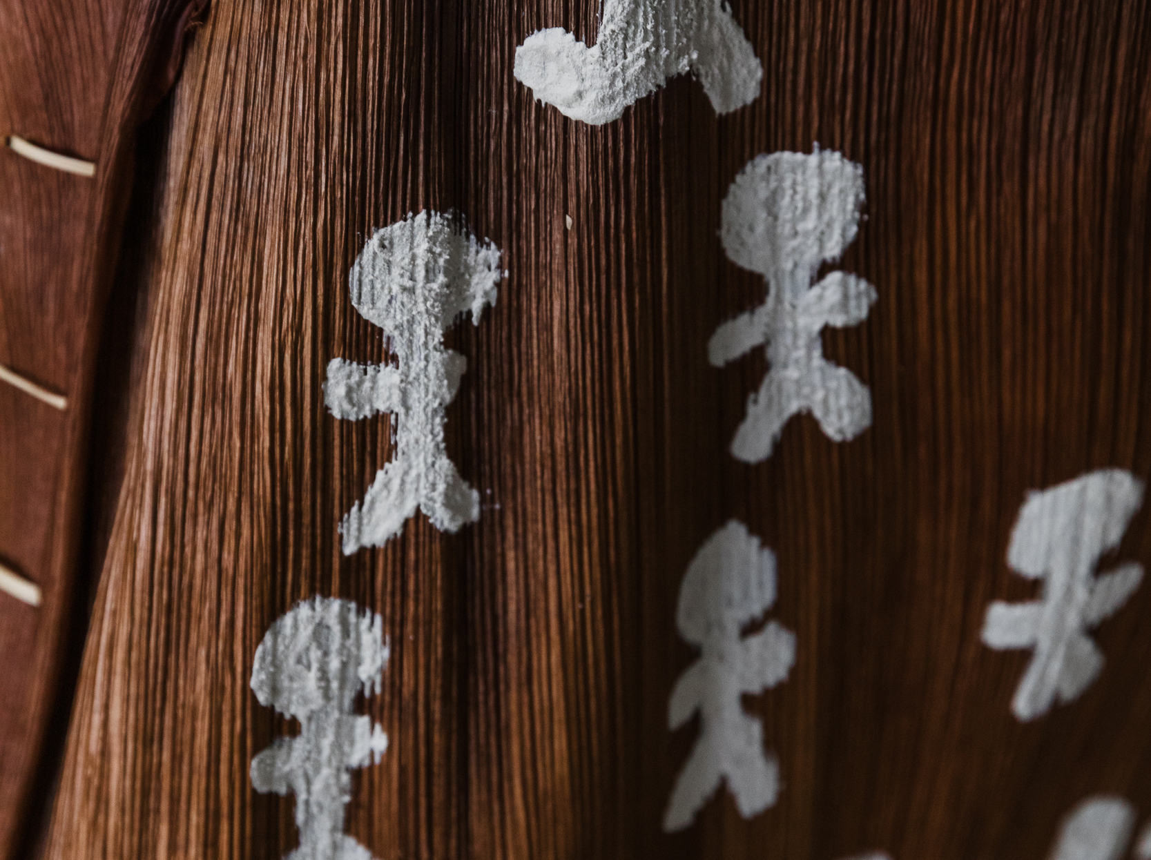 An artwork by Margaret Torrens, white painting on bangalow palm