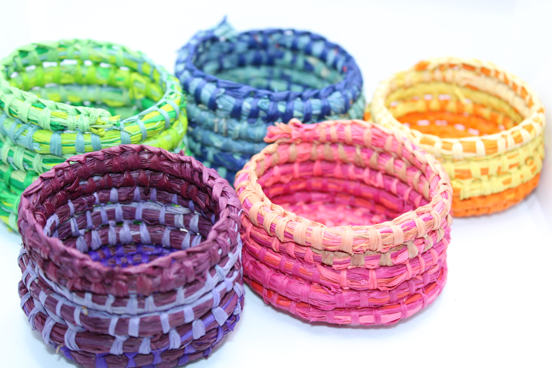 5 small colourful woven baskets