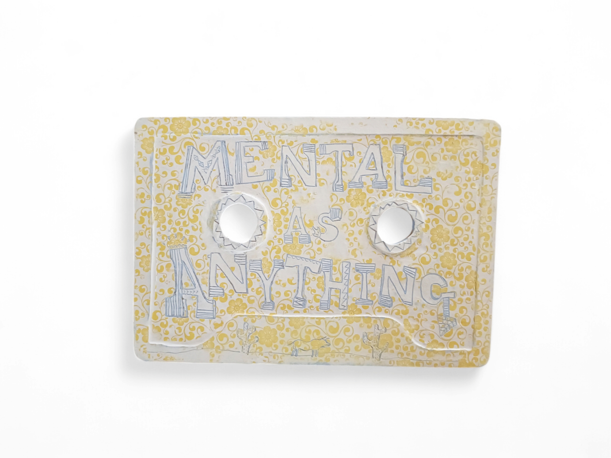 ceramic cassette tap with yellow background and 'Mental As Anything' title