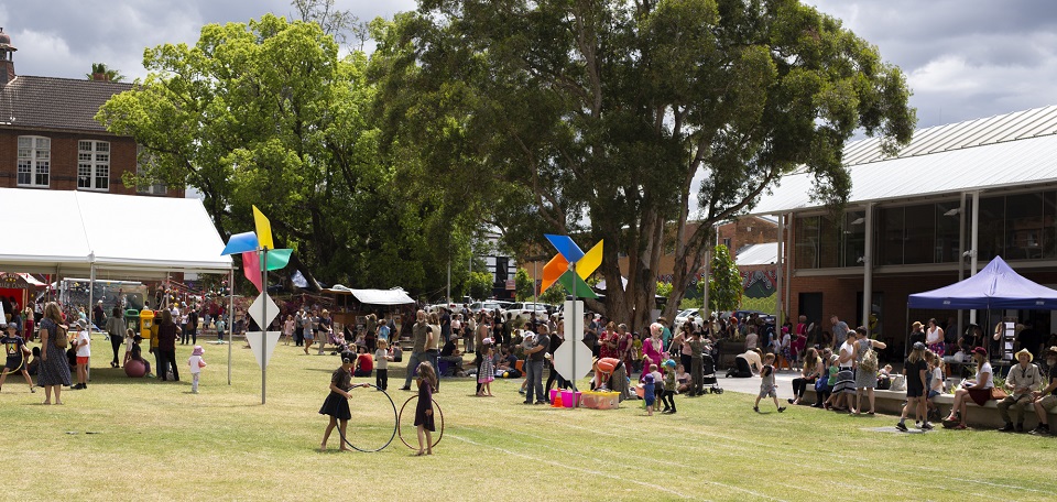 A landscape image of the Lismore Quadrangle with people and marquees
