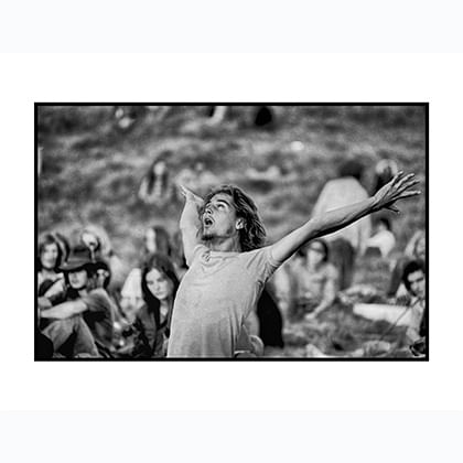 Man dancing in foreground with crowd behind.