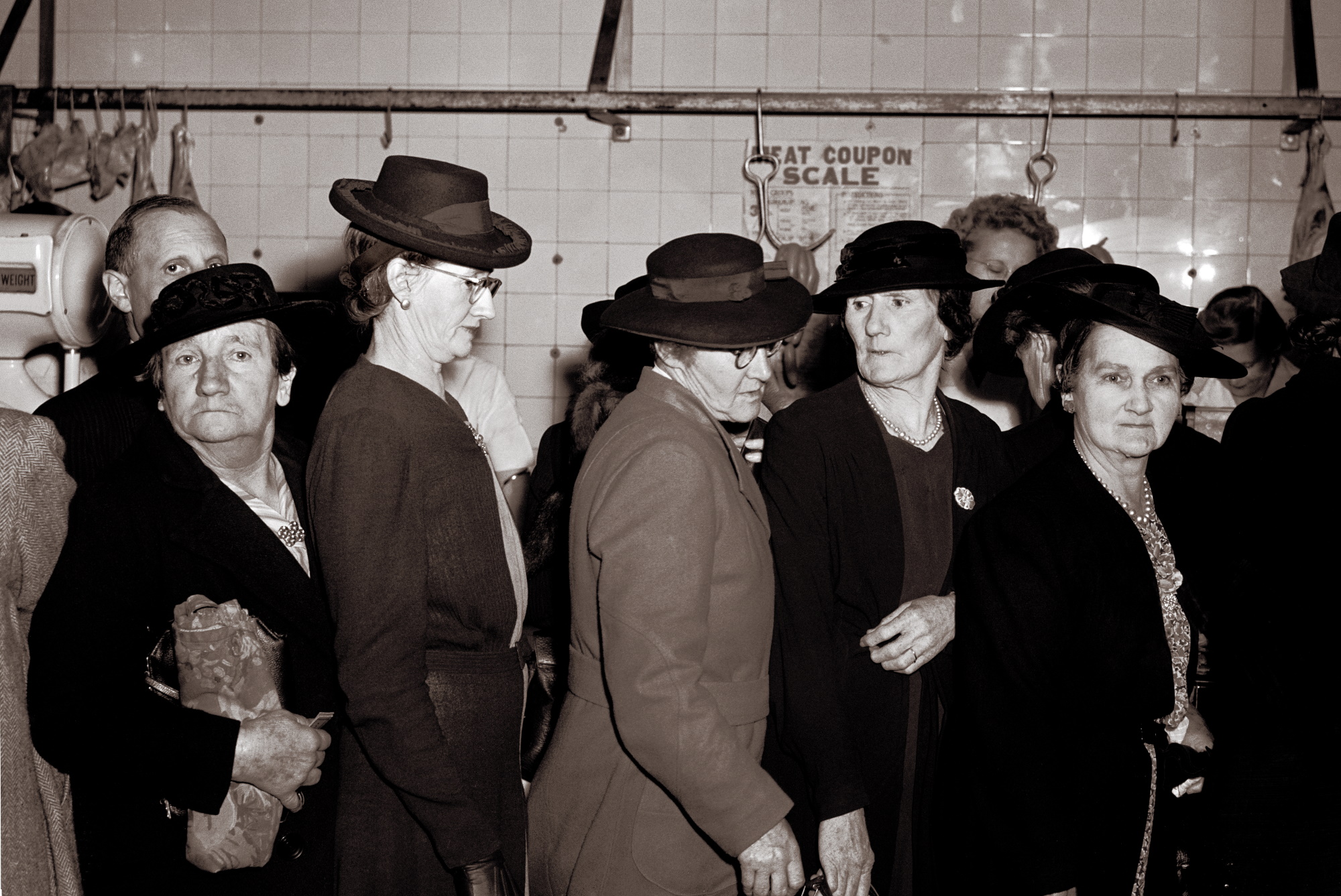women in queue in butcher shop