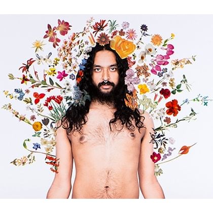 man surrounded by flowers