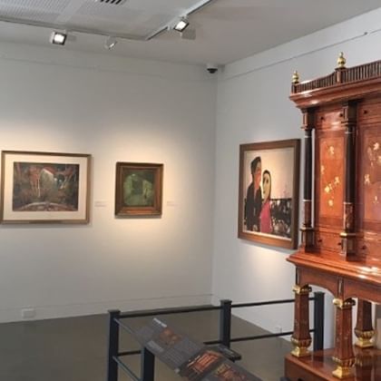 exhibition view of three artworks and part of the Hannah Cabinet