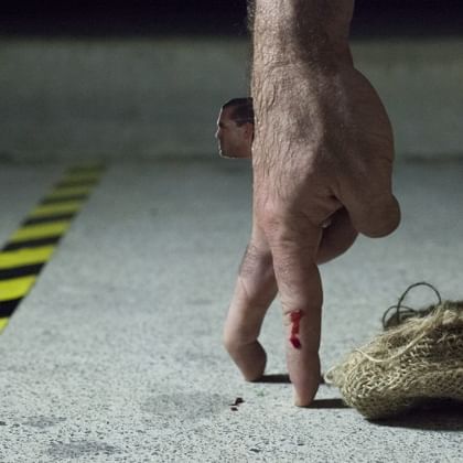 a hand with fingers walking and miniature man's head attached looking forward