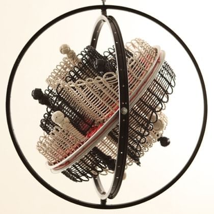sculpture with bicycle rims  and woven form within them