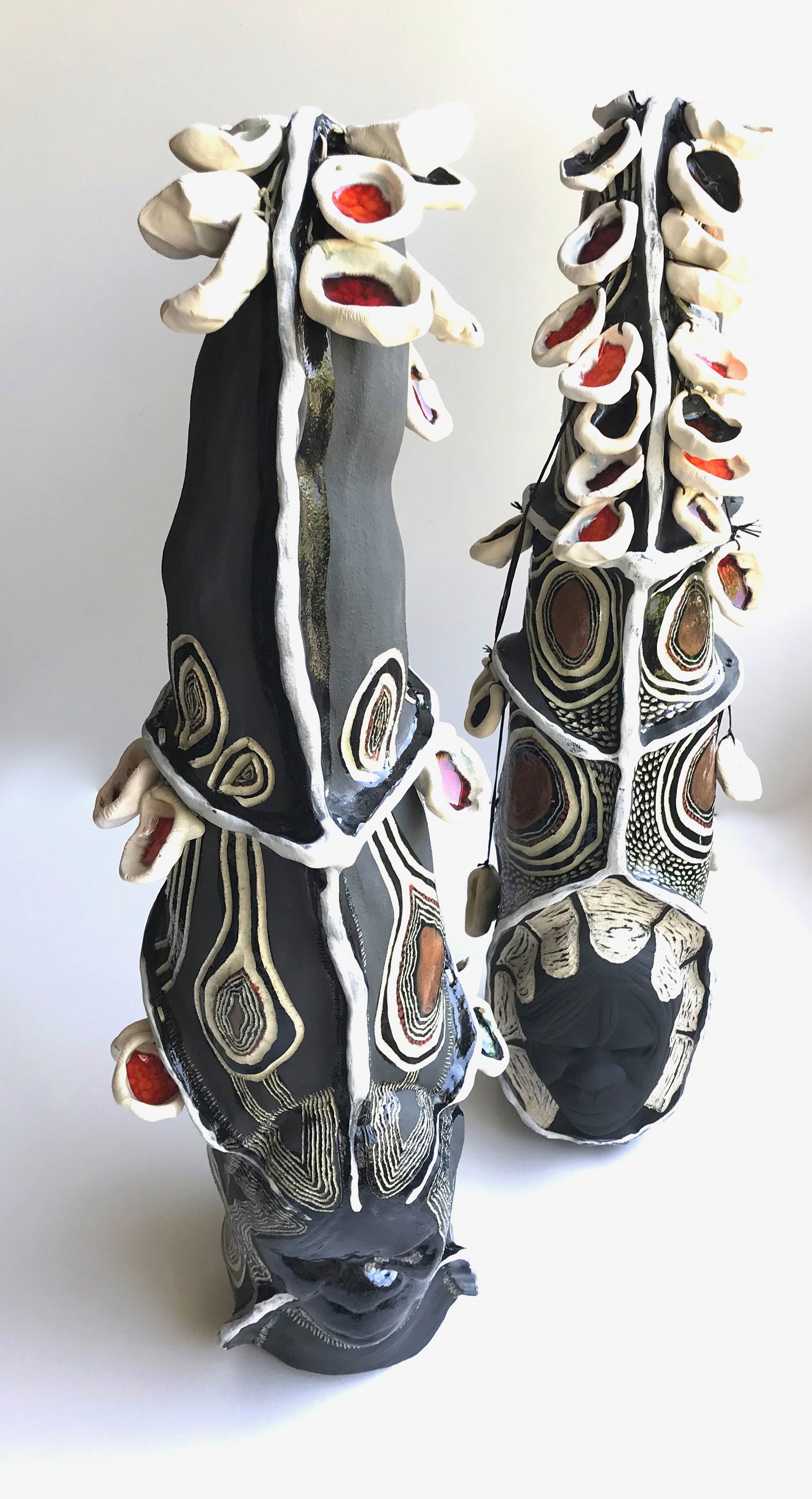 ceramic sculpture of heads with decorative headpieces