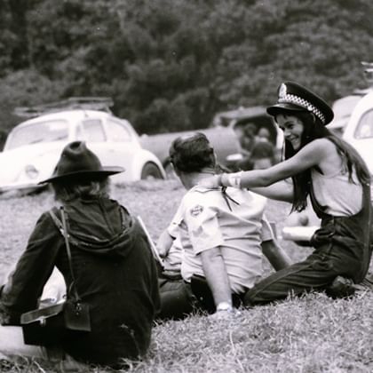 protesters sitting with policman, giving him a massage