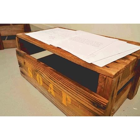 large soapbox with sheets of paper with text on top