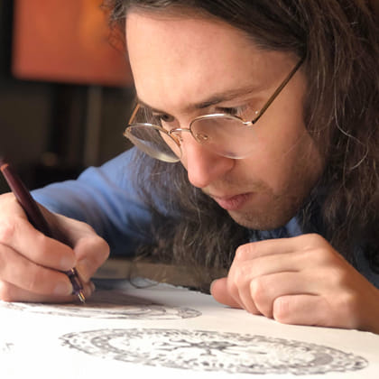 photo of Jack Stahel drawing with pen 