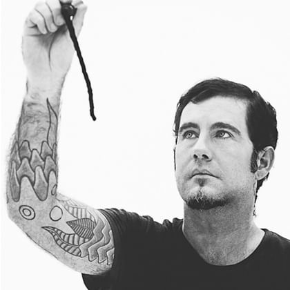 photo of Jeremy Hawkes with his arm raised