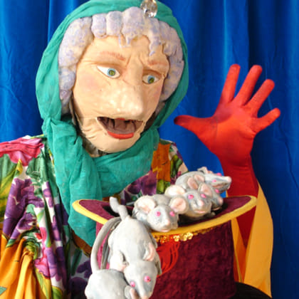 puppet of old woman with a plate of mice