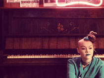 person sitting in front of a piano