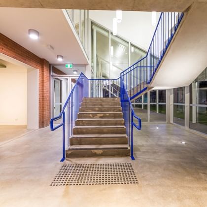 building interior with staircase with blue rails centre shot
