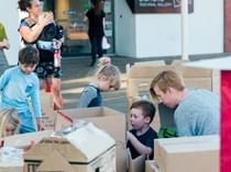 group of children making buildings from boxes