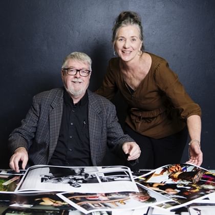 Jacklyn Wagner and Peter Derrett with a pile of photographs 