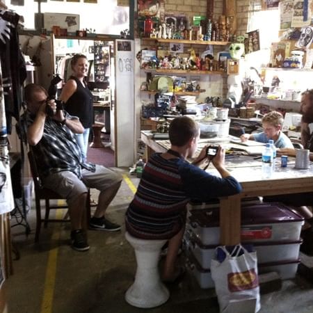 people around a table making artwork and taking photos