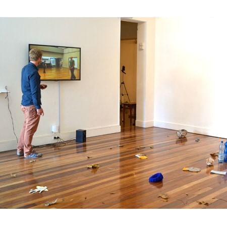 Man standing  in room watching scene