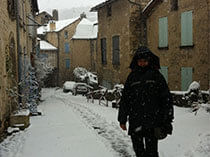 person walking down snow covered street