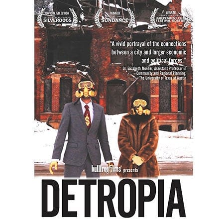 two people wearing gas masks in front of a build in snow covered ground 