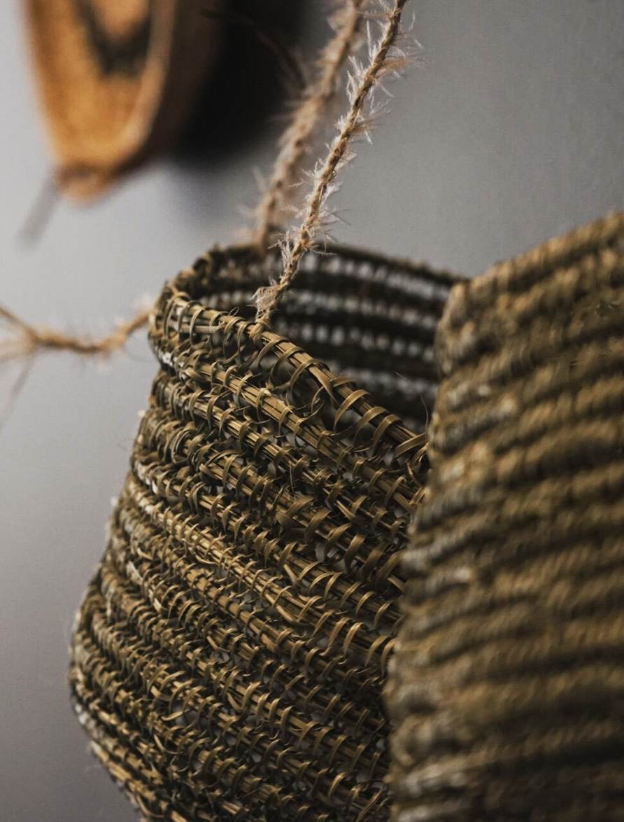 Two woven baskets hanging on a wall