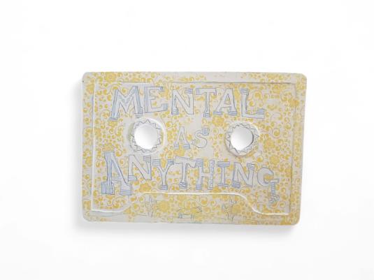 ceramic cassette tap with yellow background and 'Mental As Anything' title