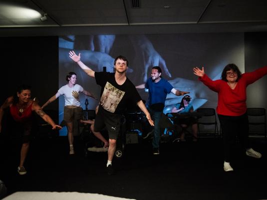 A groups of people with mixed ability dancing in the gallery