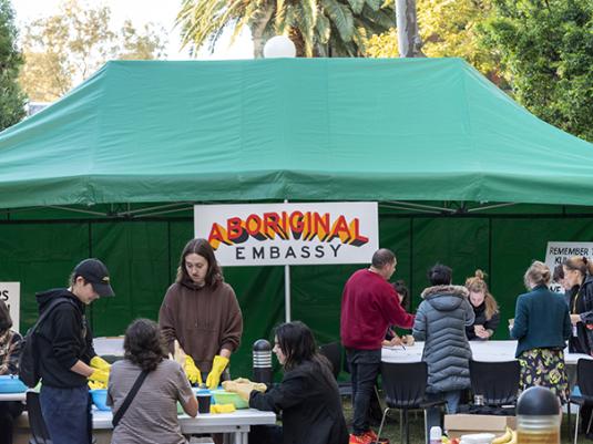 A photo of the 'Aboriginal Embassy' artwork with people during an event