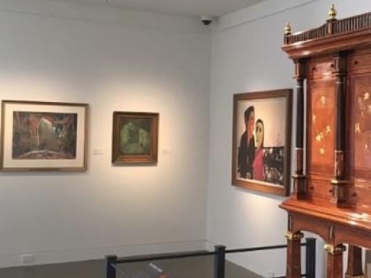 exhibition view of three artworks and part of the Hannah Cabinet