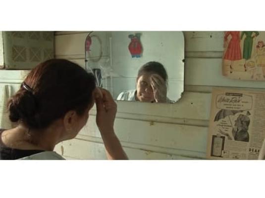 woman looking in mirror