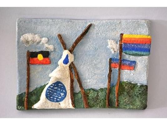 relief sculpture of a tent and flags including Aboriginal flag