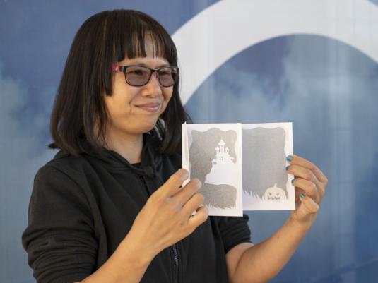 image of Hilda Wang holding a card