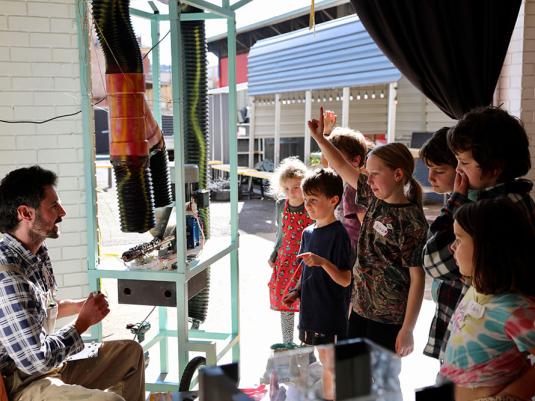 children listening to artist