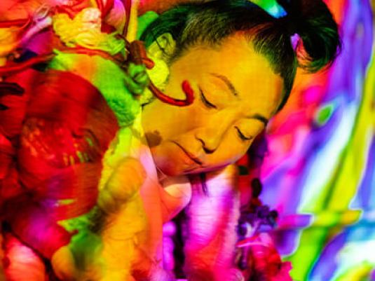 Hiromi Tango surrounded by colourful sculpture