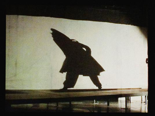 video still of person walking in hooded coat