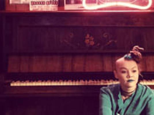 person sitting in front of a piano