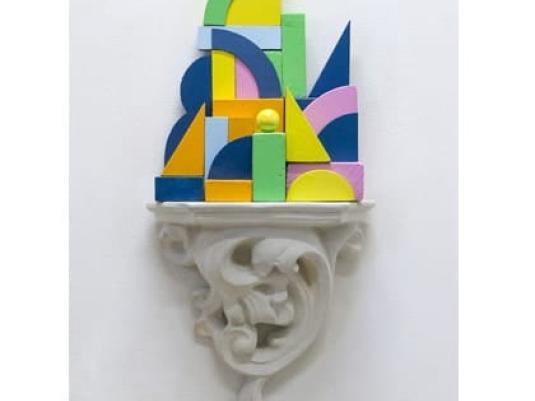 decorative plaster shelf with sculpture constructed of wooden blocks