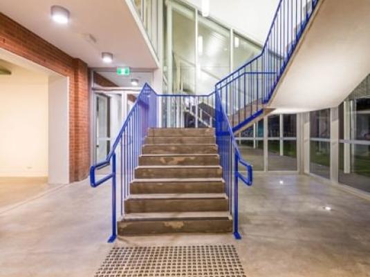 building interior with staircase with blue rails centre shot
