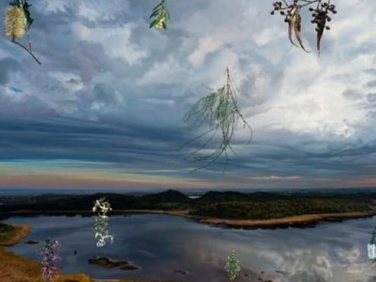 painting of landscape with cloudy sky and orange sunset with the sky reflected in lake in centre of image