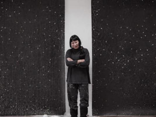Artist Lindy Lee standing in gallery