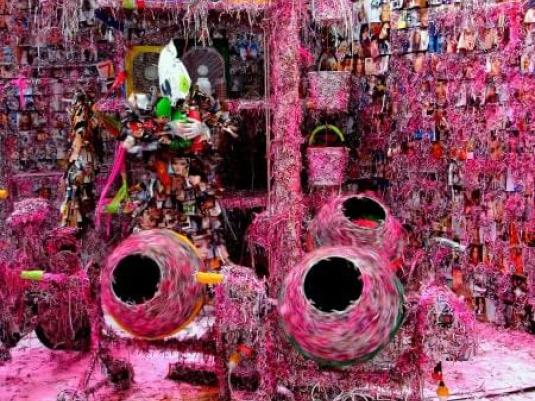 abstract scene that includes buckets cement mixers and multiple images, all covered in bright pink substance t